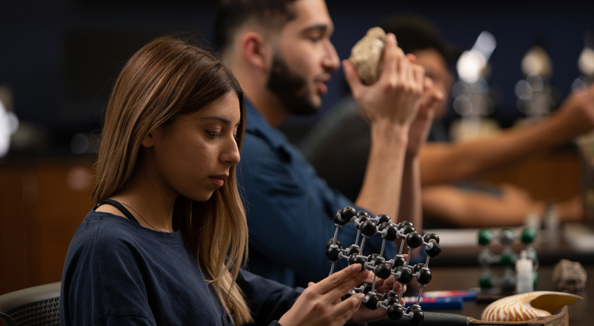 woman looking at molecule figure