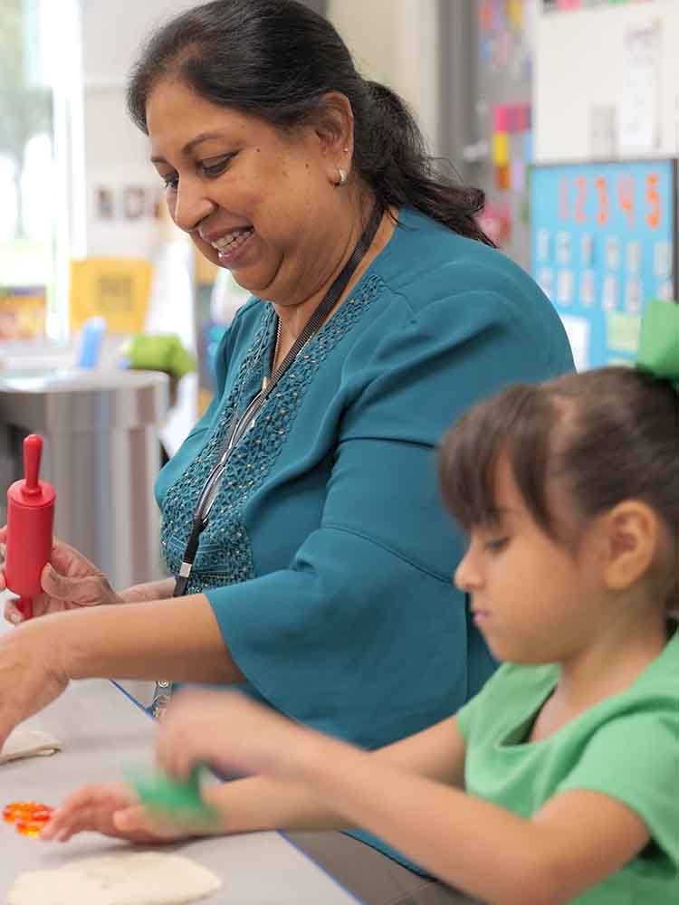 Early childhood educator guiding children in play-based learning