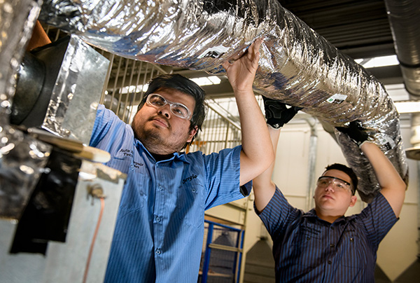 HVAC students installing air ducts