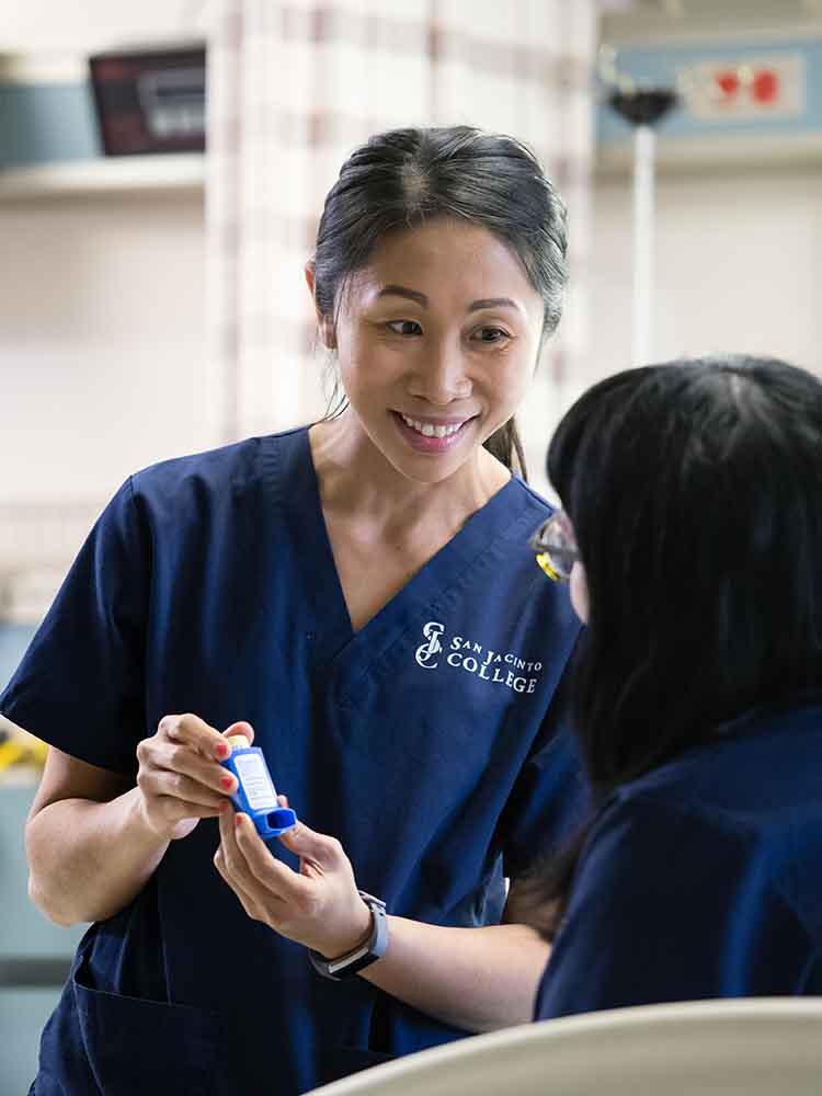 respiratory care therapist showing patient inhaler