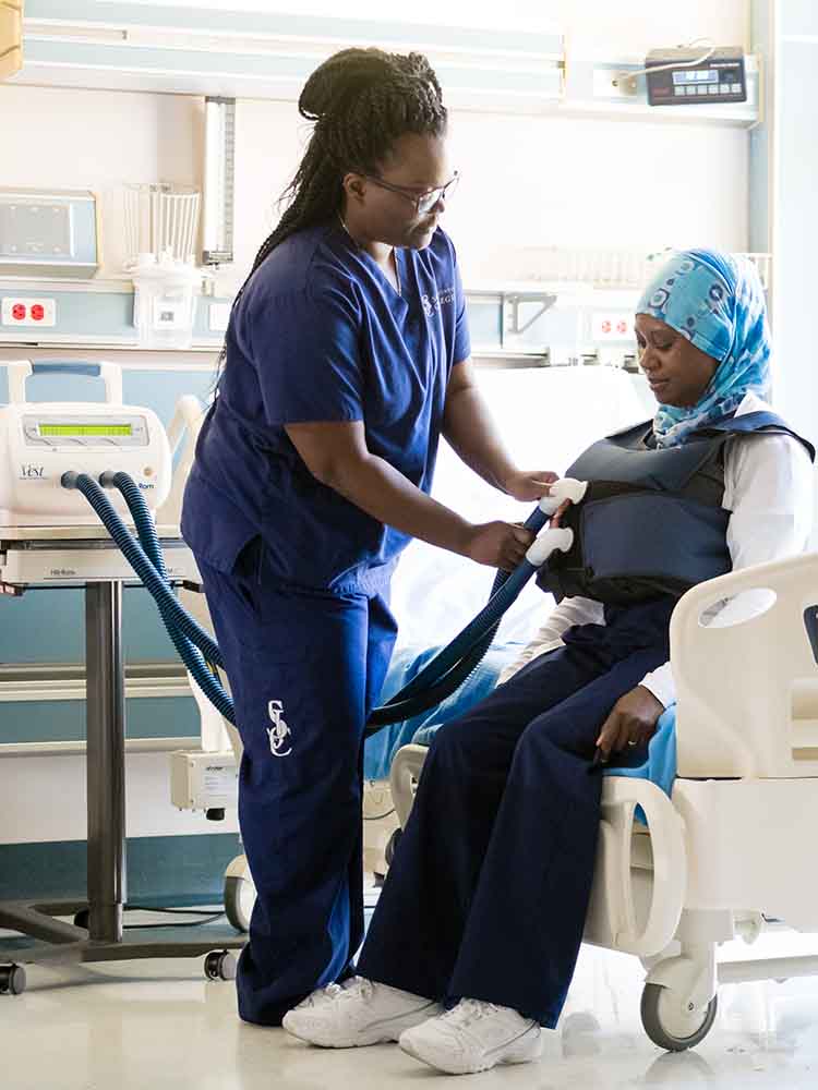 respiratory care therapist placing device on patient