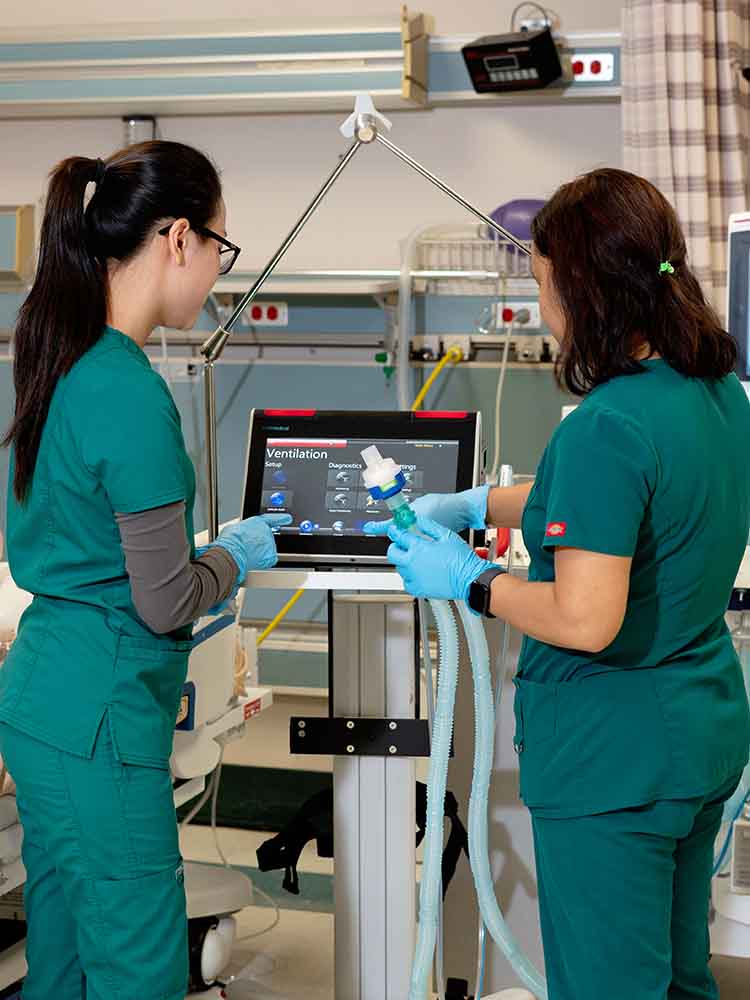 respiratory care therapists checking monitor