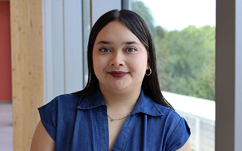 San Jacinto College Promise Scholar Dariana Zavala standing in front of a window