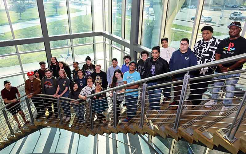 San Jacinto College esports students and advisor posing for group photo on staircase