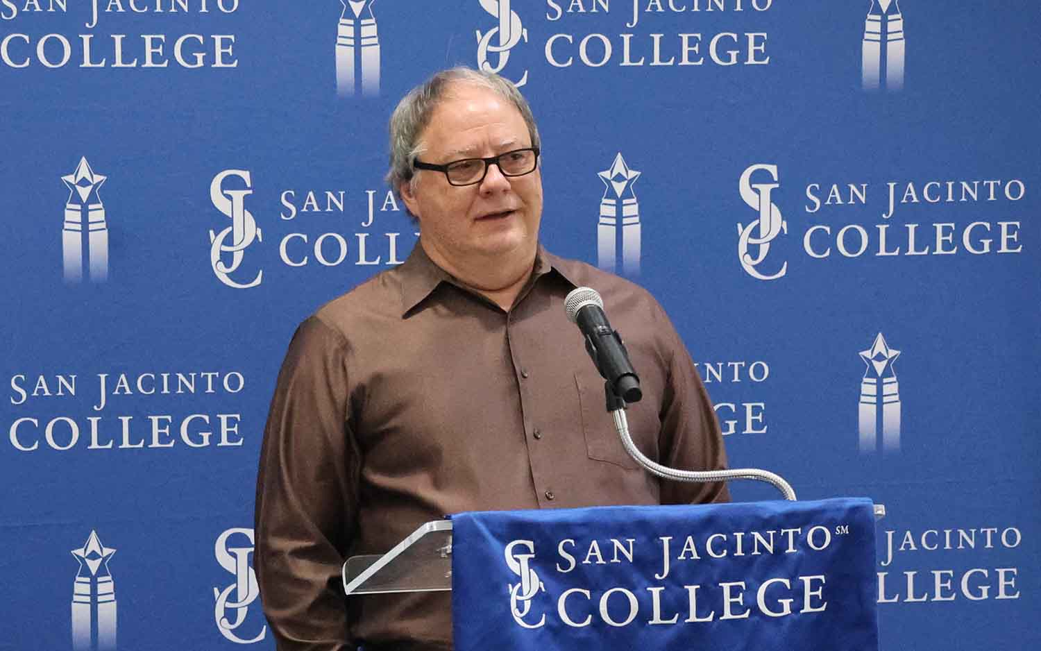 Marie Flickinger's son David speaking at the ribbon-cutting event.